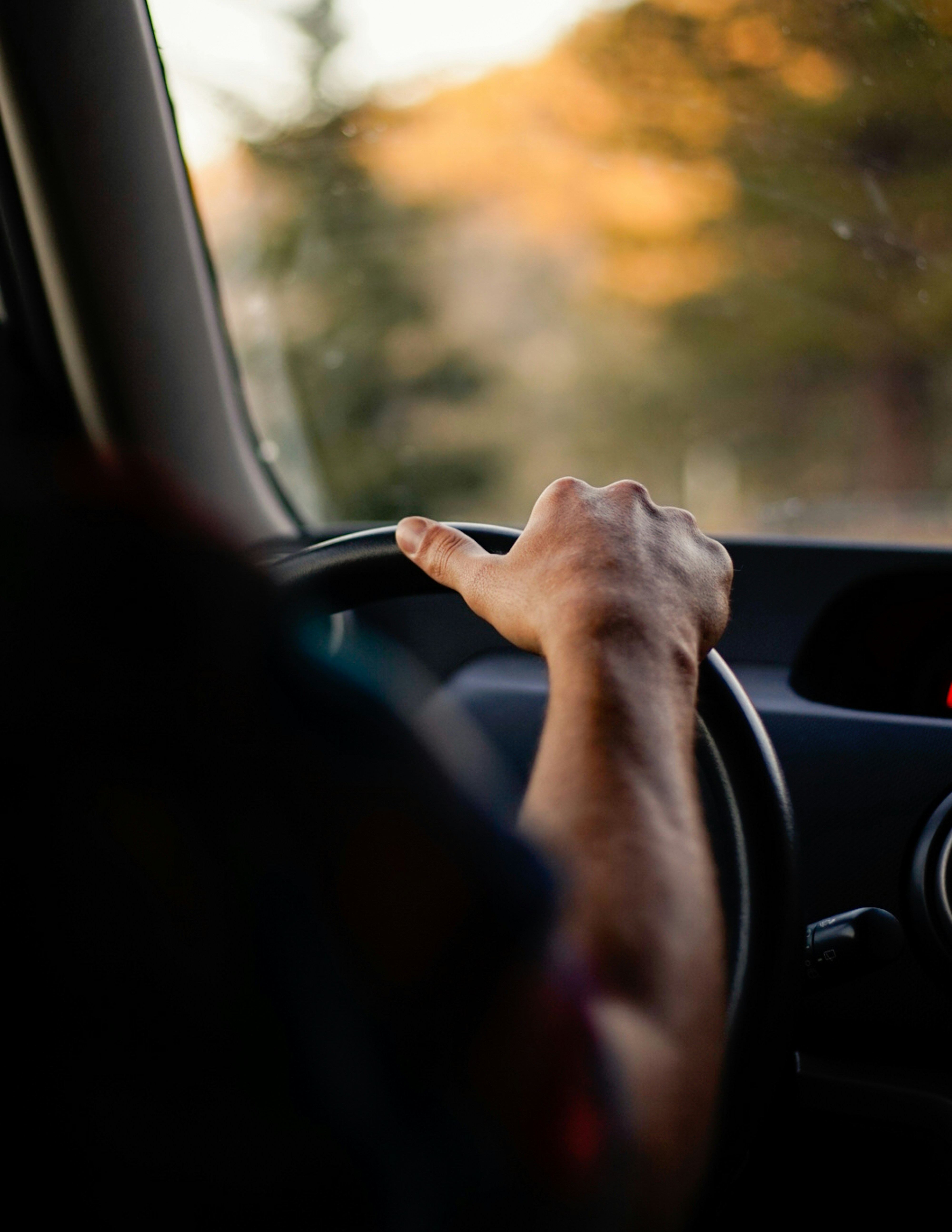 A learner's hands on the wheel during a driving lesson